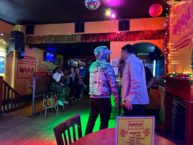 People singing karaoke at The Bangkok Lounge
